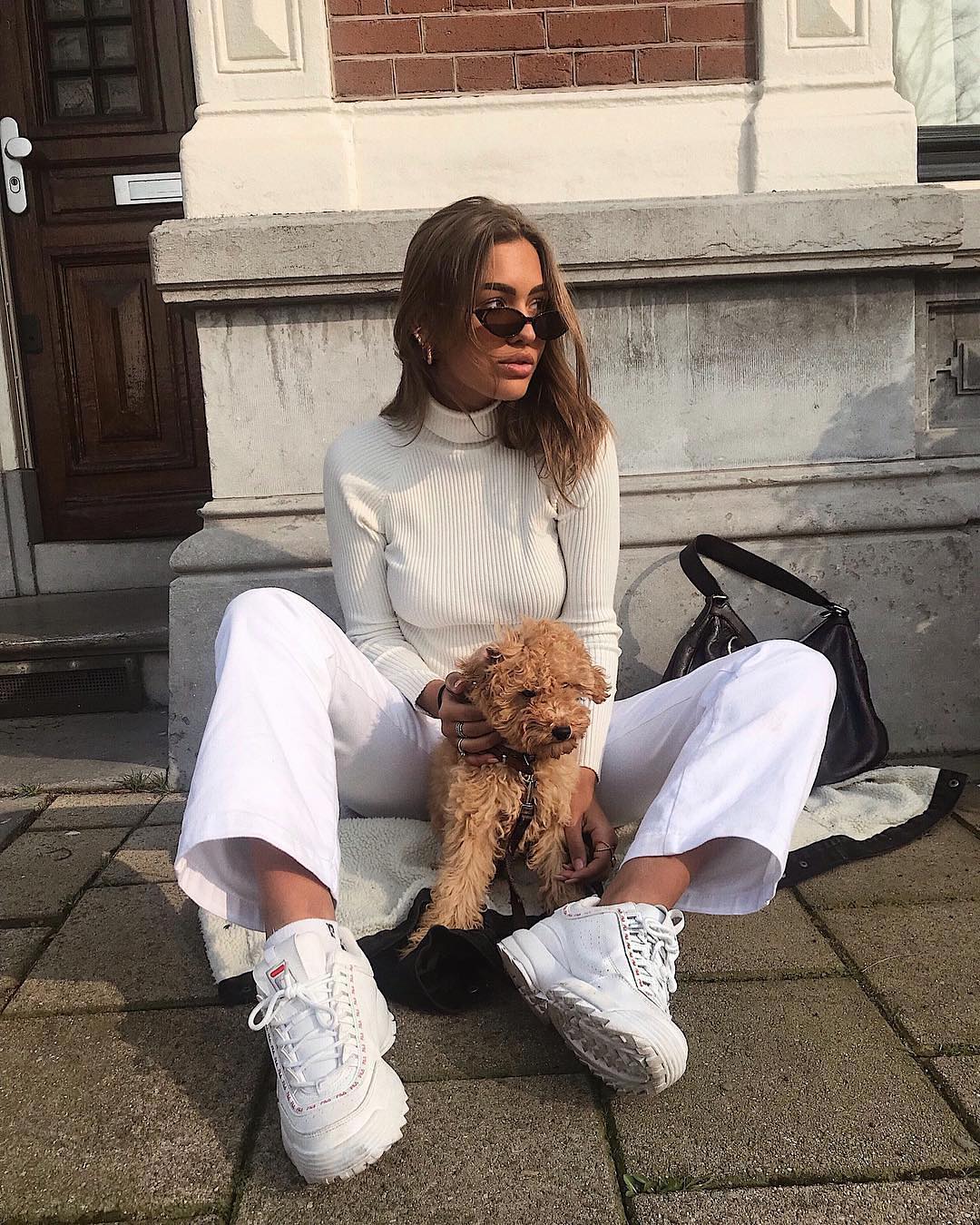 All in white with sneakers and cat-eye sunglasses for spring 2021