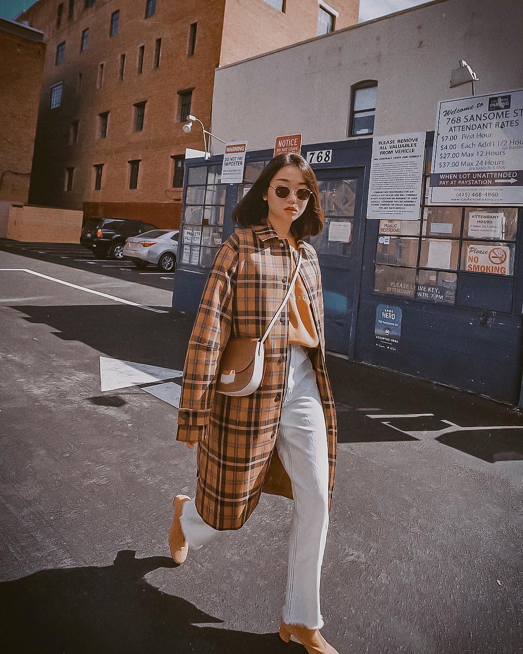 Long plaid coat with a cream-colored beige sweatshirt and high-rise jeans in Wash Blue 2021