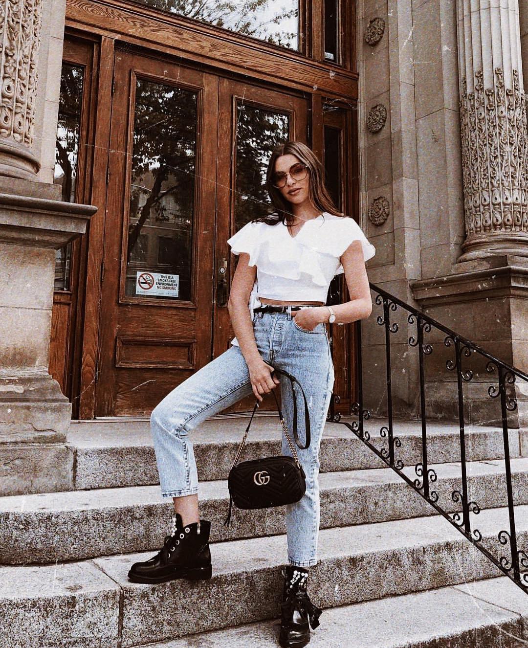 Ruffle white crop top and wash blue jeans with black combat boots for spring 2021