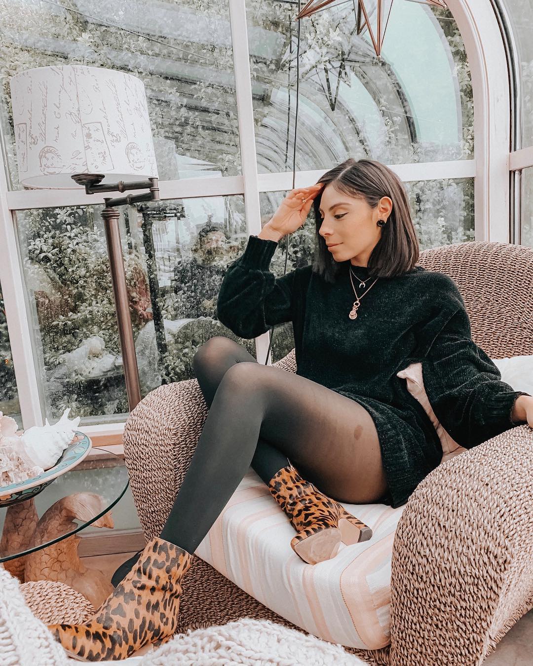 Shiny black sweater dress, pantyhose and leopard print ankle boots for fall 2021