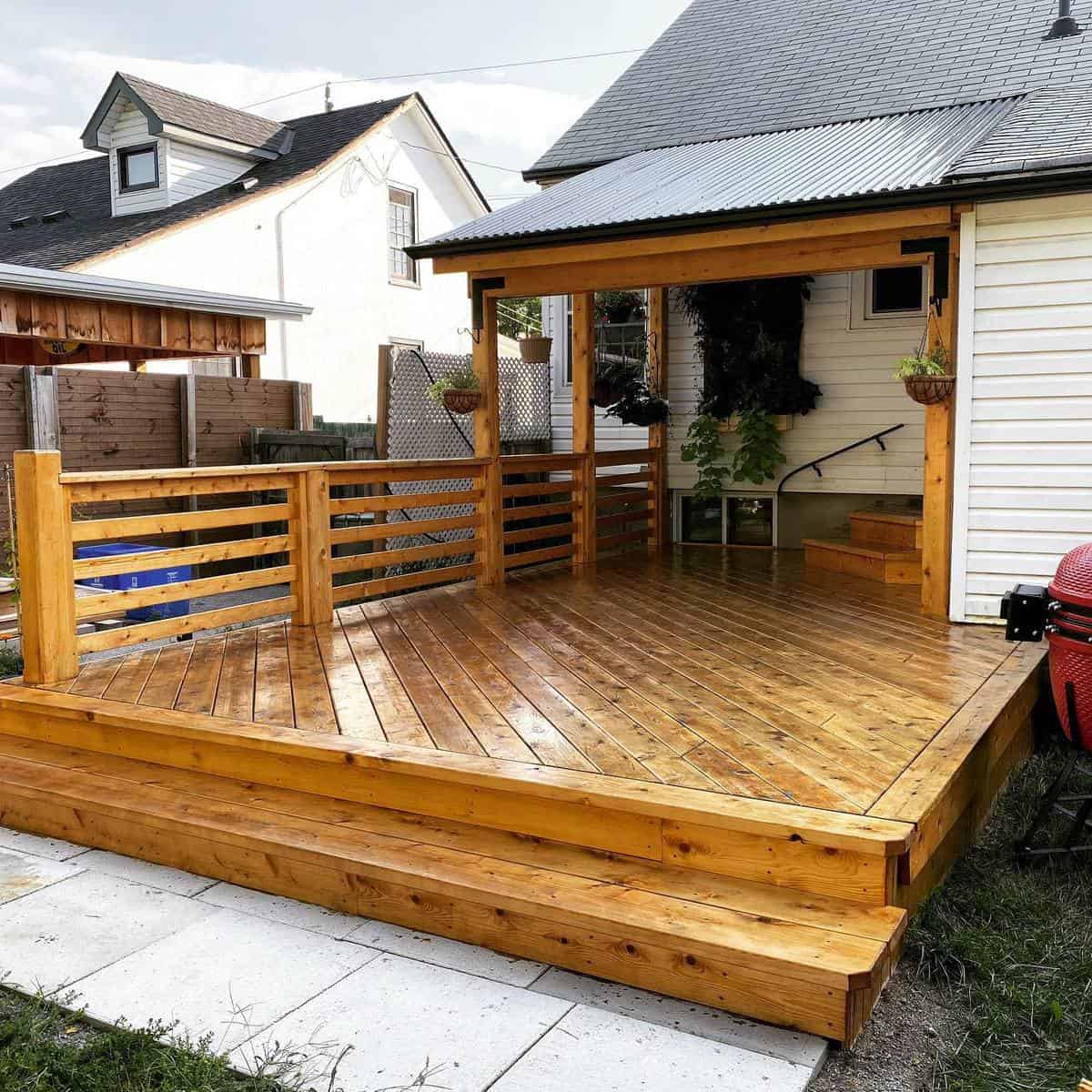 Patio railing made of stained wood, slate paving stones