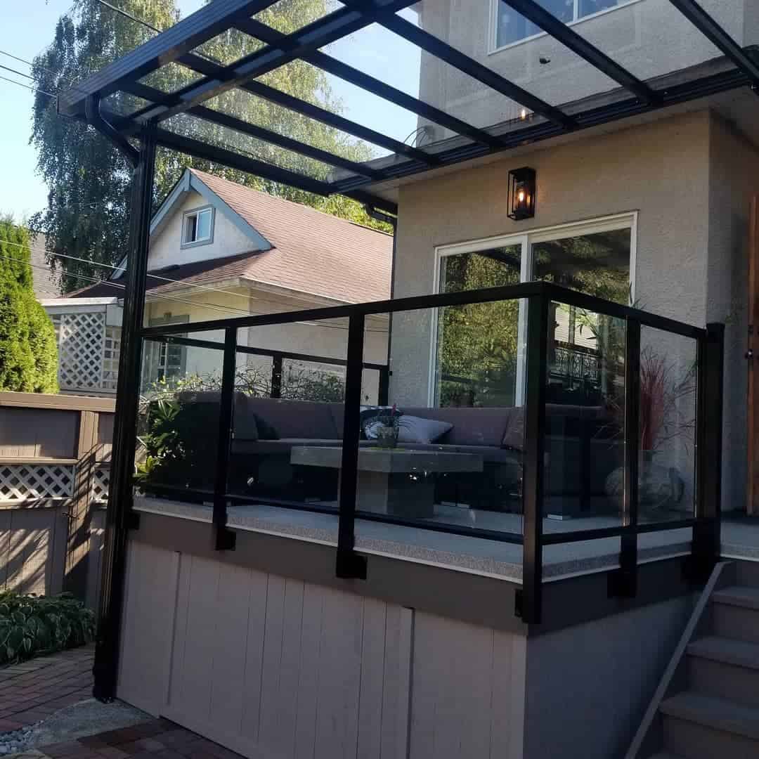 small raised black sofa with slate deck in backyard