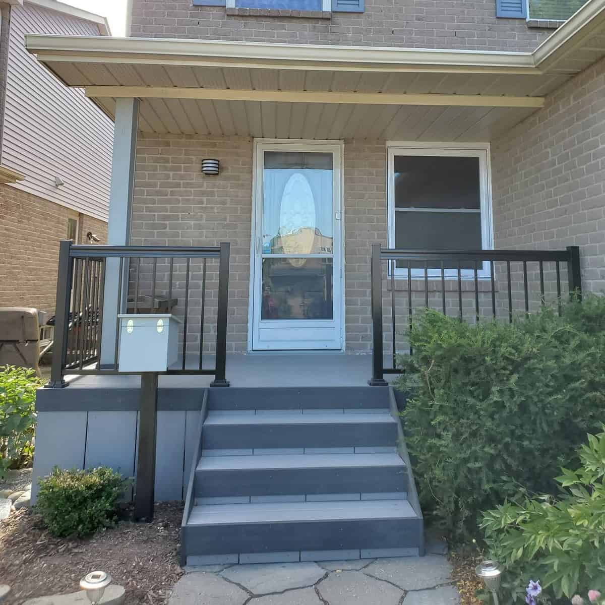 two-tone gray deck with black railing