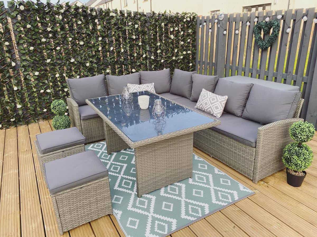 Wooden deck, gray wicker furniture 