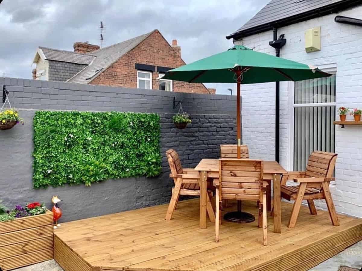 Small table setting with wooden deck and parasol 