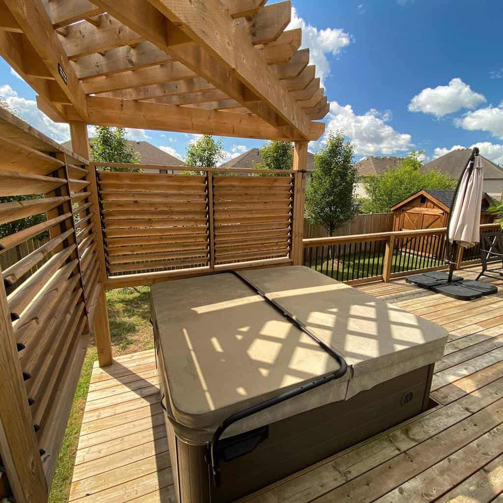 Simple backyard spa covered with a wooden deck