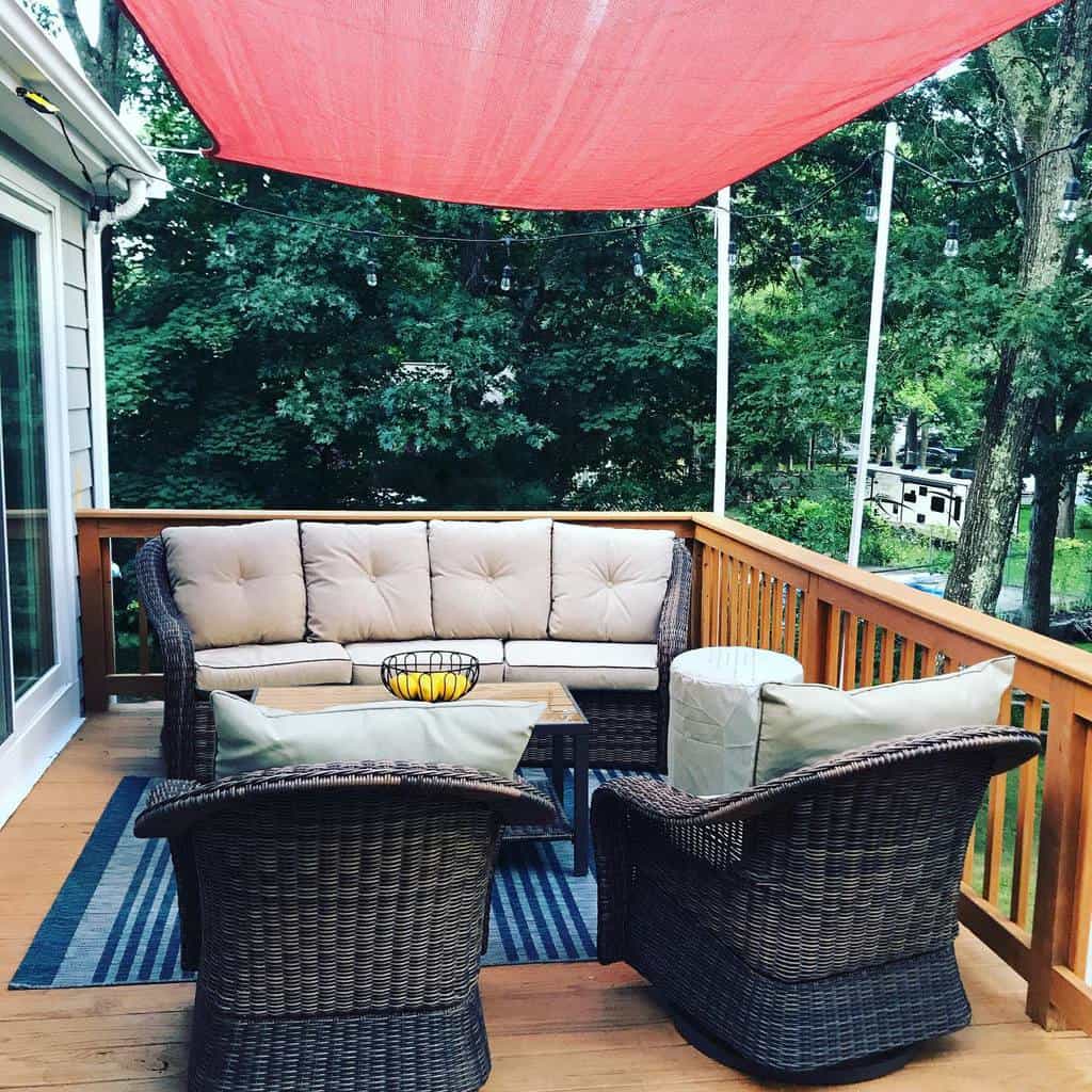 Outdoor wooden deck, red patio, wicker chairs with shade 