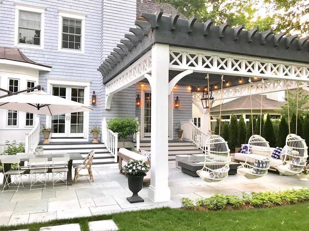 Large paved patio, luxury country style dining table, parasol, hanging egg chairs 