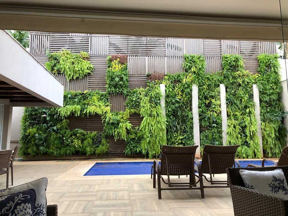 Resort style vertical garden with wicker furniture with pool 