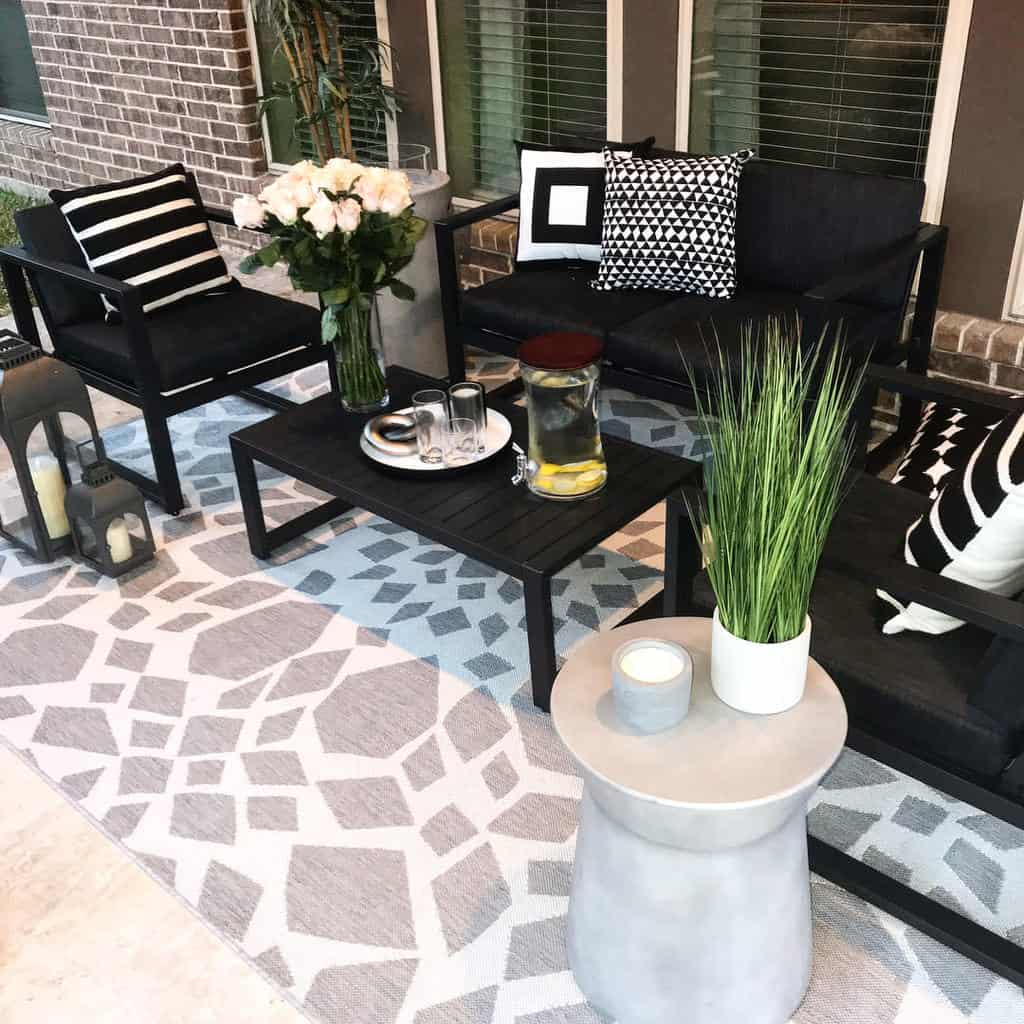 Porch and patio patterned rug, black wooden furniture 