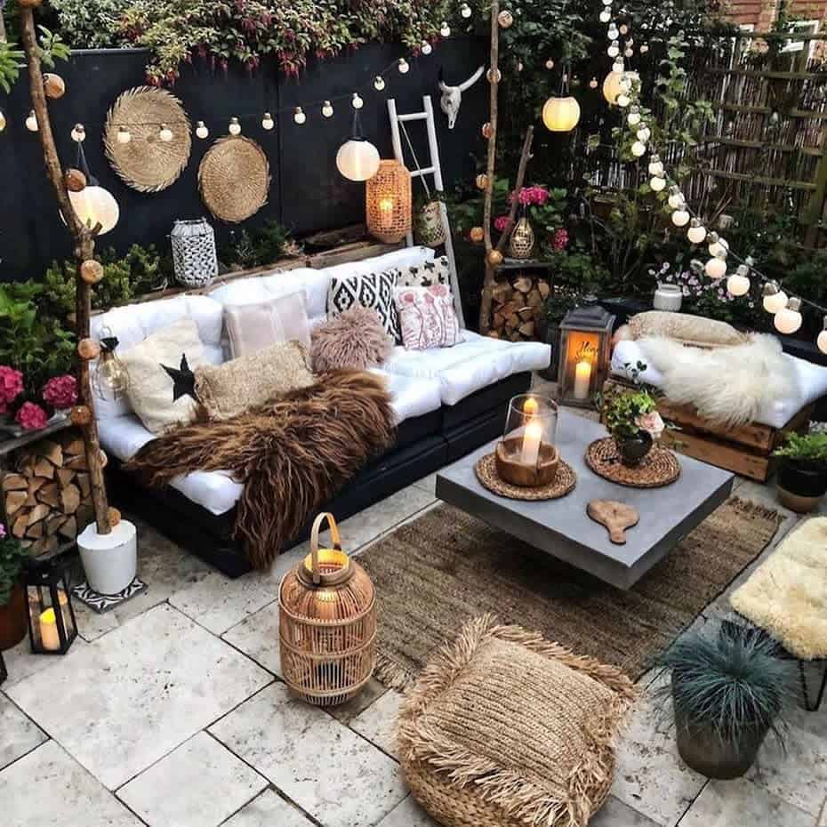 Paved stone terrace, rustic flair, wicker furniture, hanging lamps
