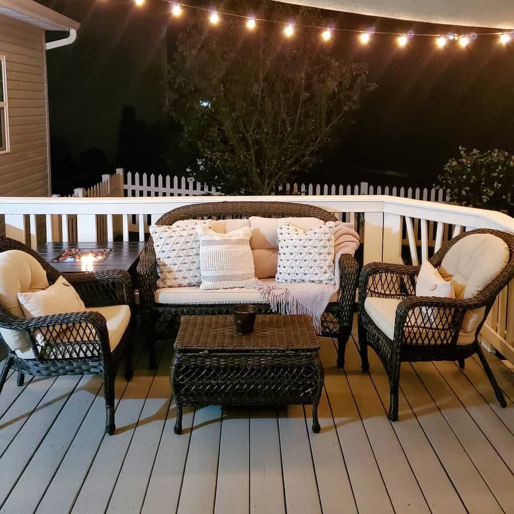 Rustic wooden patio with black wicker furniture 