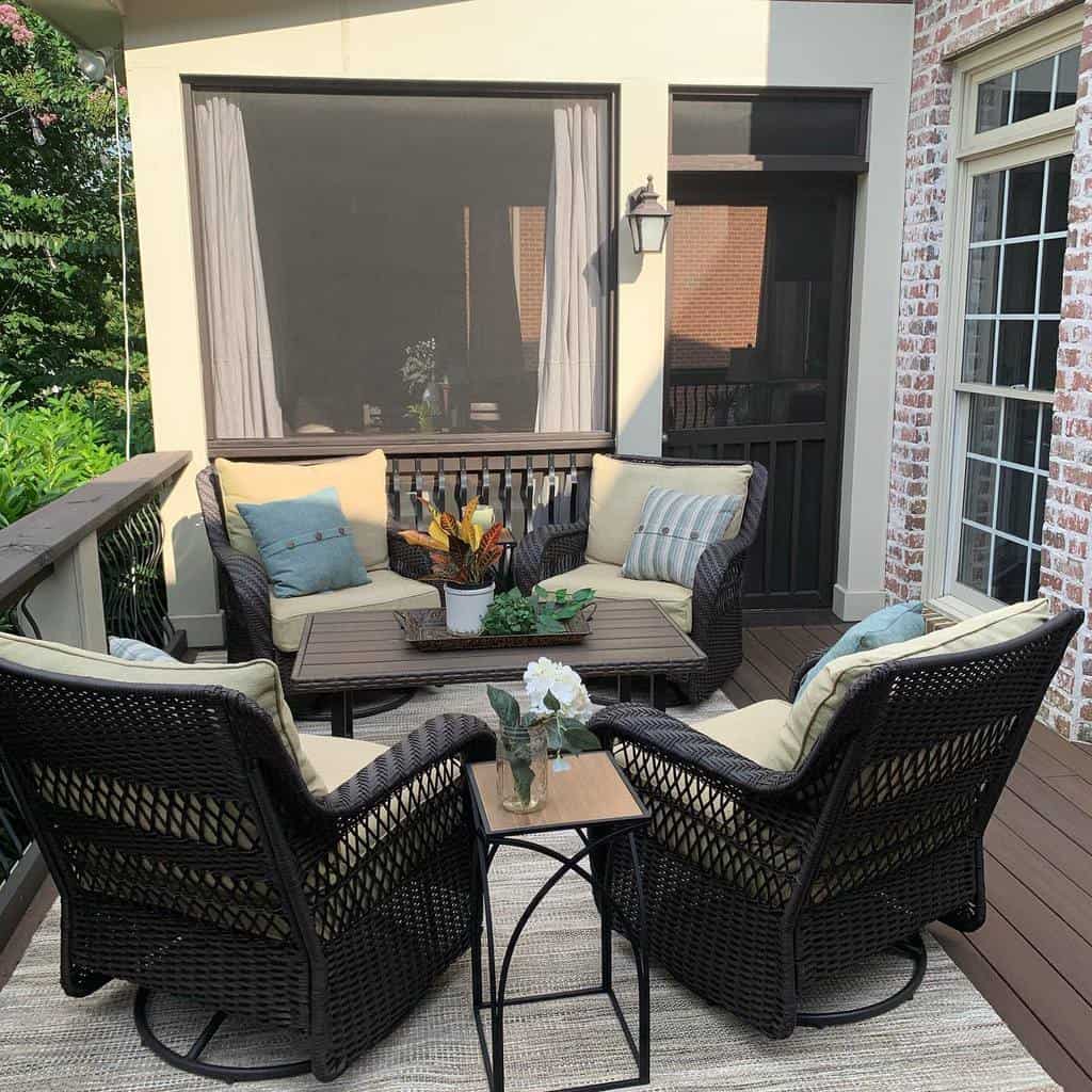small patio floor made of wood, wicker, patio furniture
