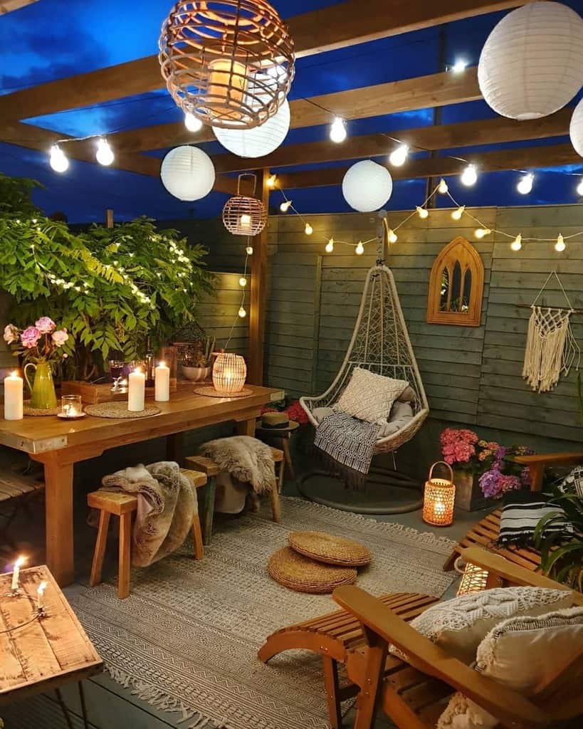 Backyard patio, wooden table, hanging lights, candles 