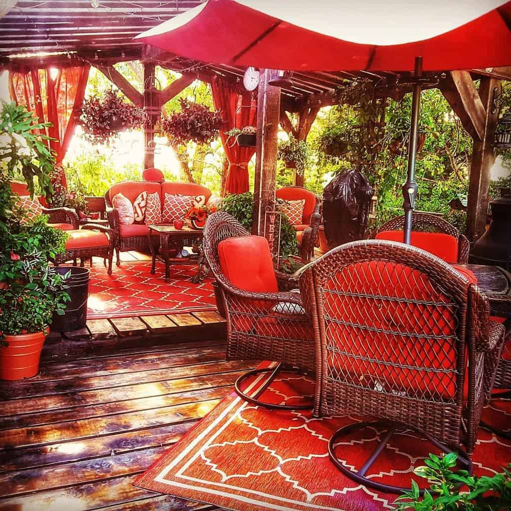 spacious outdoor terrace with red wicker furniture 