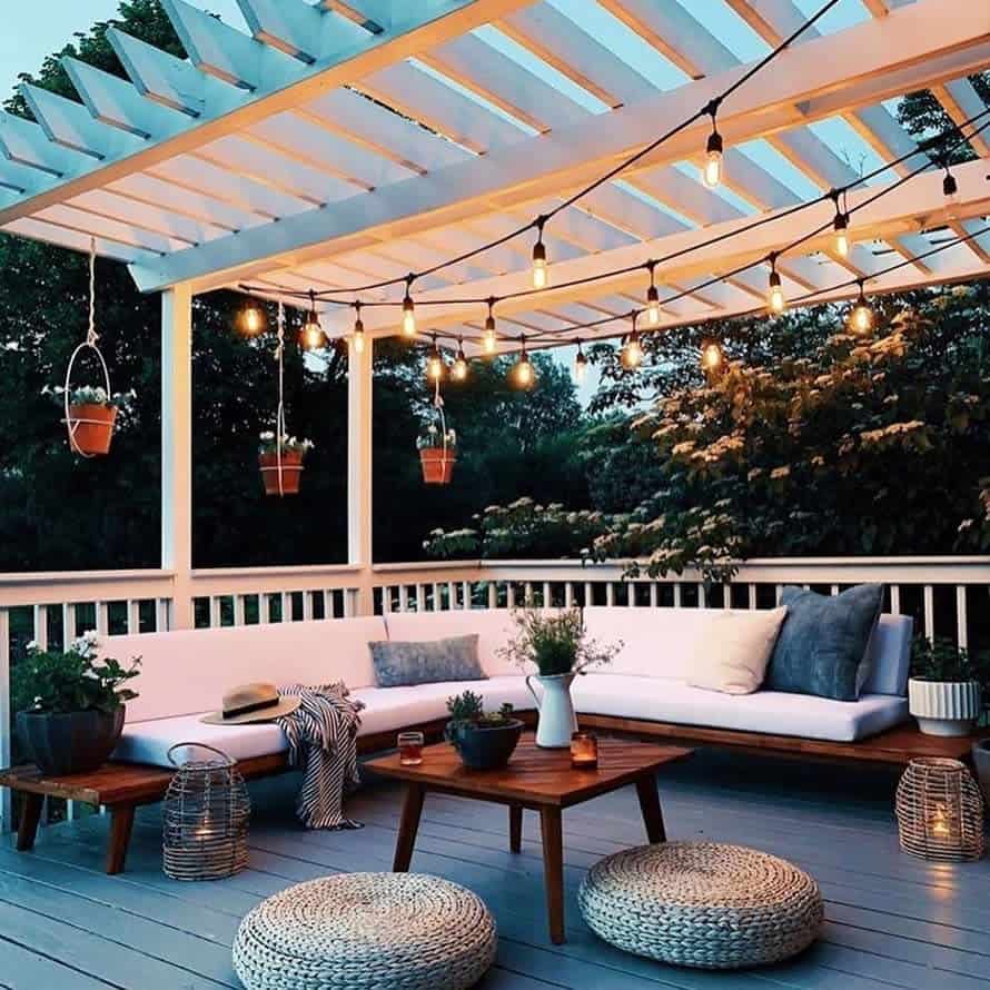 gray wooden terrace, wooden furniture, hanging lamps, potted plants