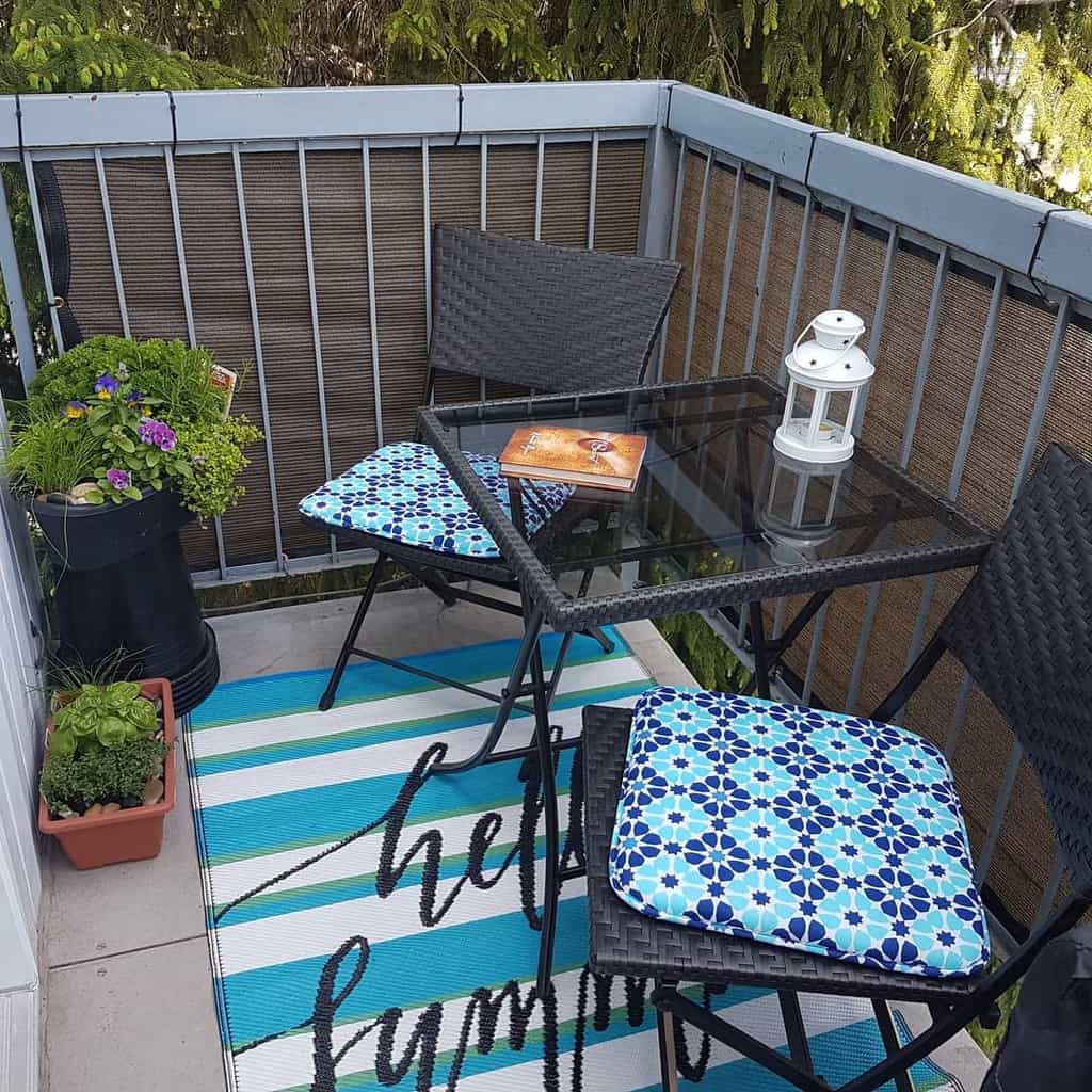 Balcony terrace with glass table and chairs 