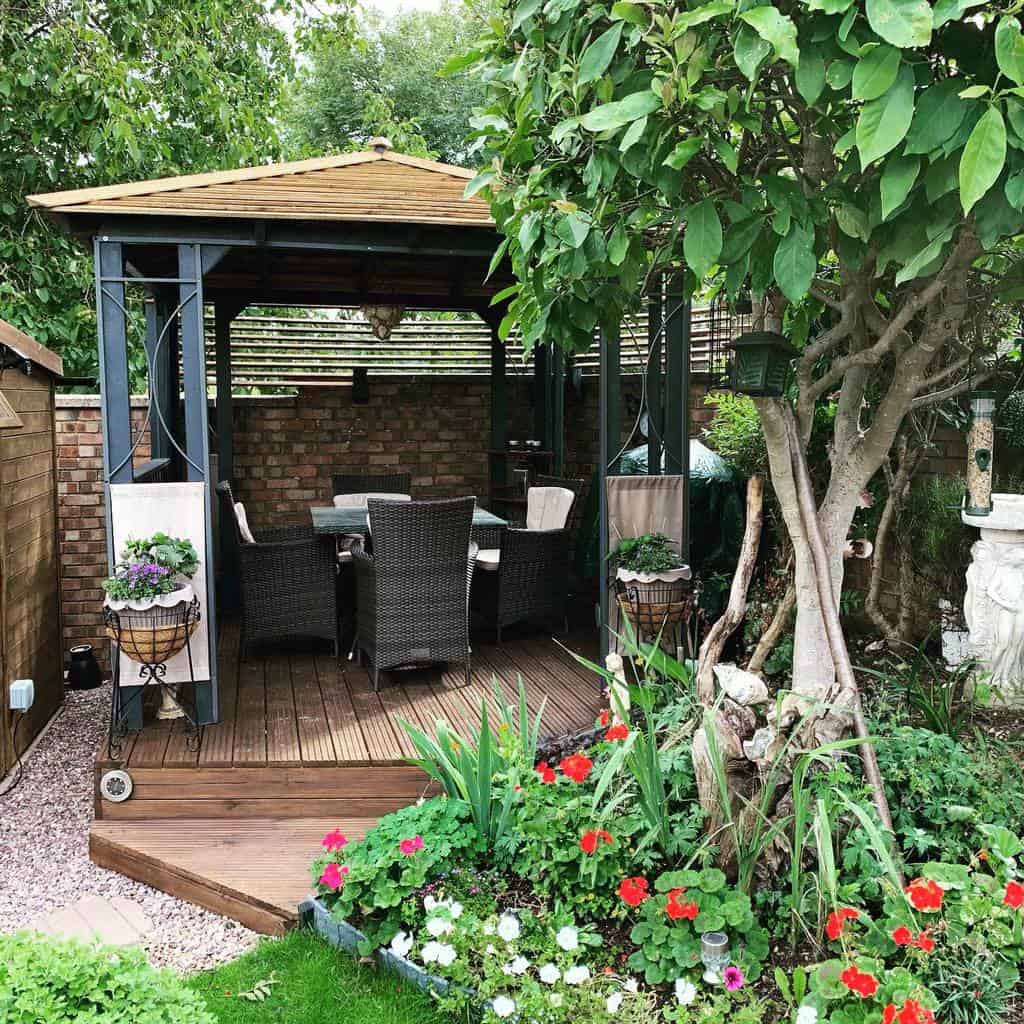 Wooden terrace with gazebo and wicker furniture 