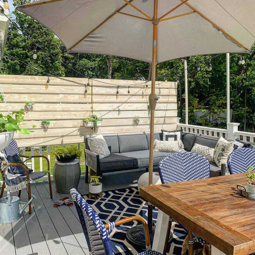 Wooden deck with privacy wall and parasol
