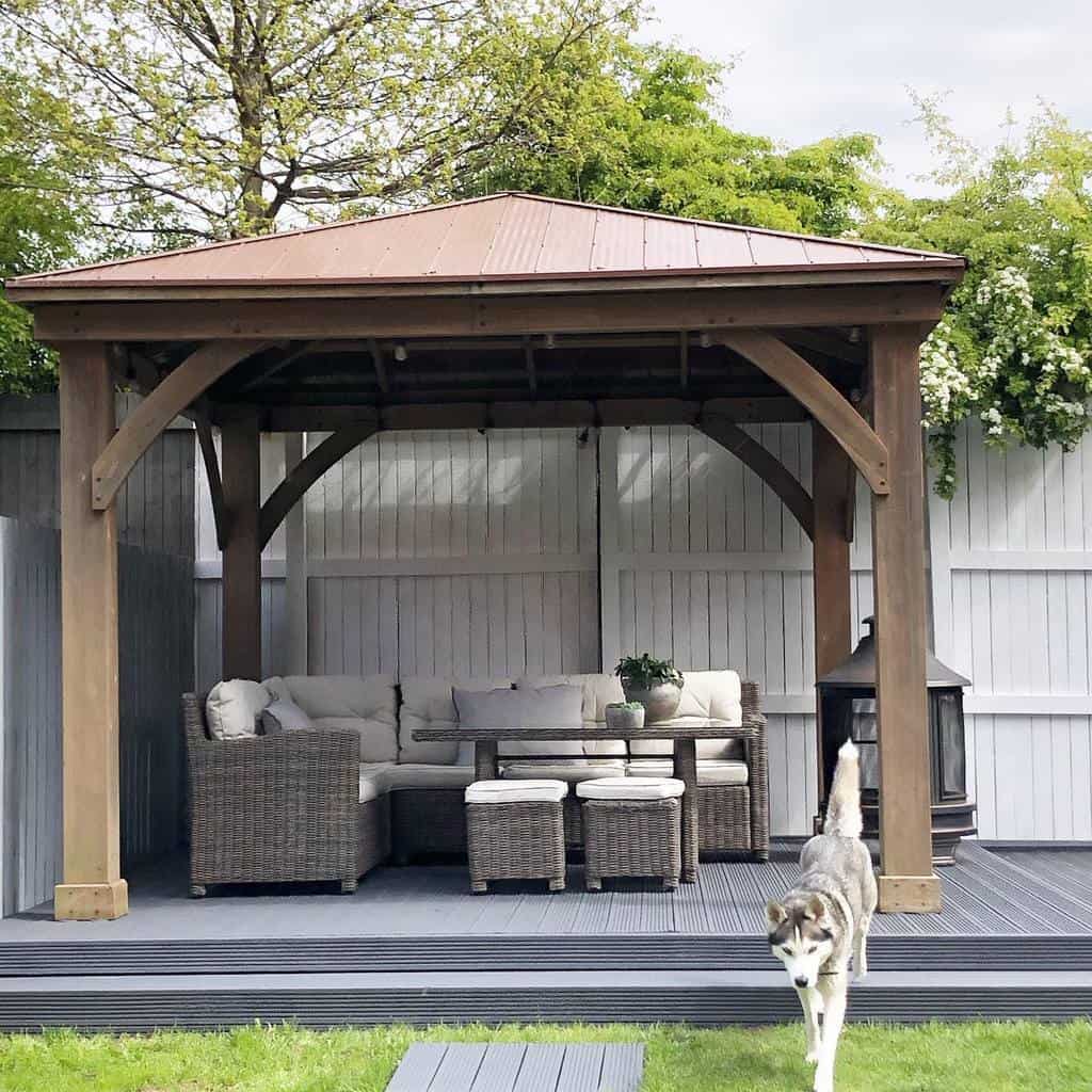 Terrace with wooden pergola and wicker furniture 