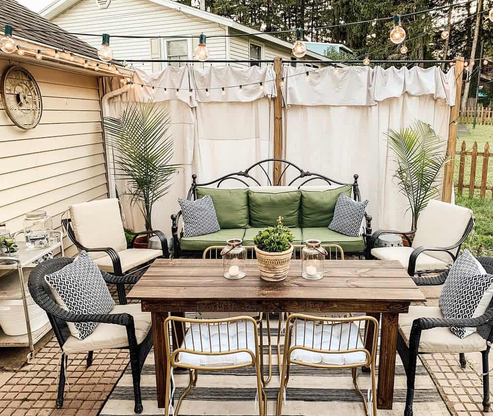 Rustic backyard patio with shaded privacy wall and vintage furniture 
