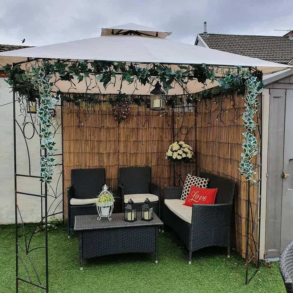 small corner garden terrace with pavilion and wicker furniture 