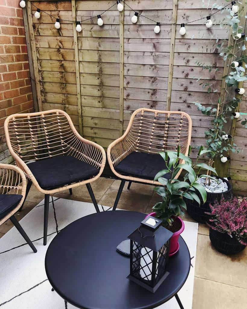 small corner garden terrace with wicker chairs 