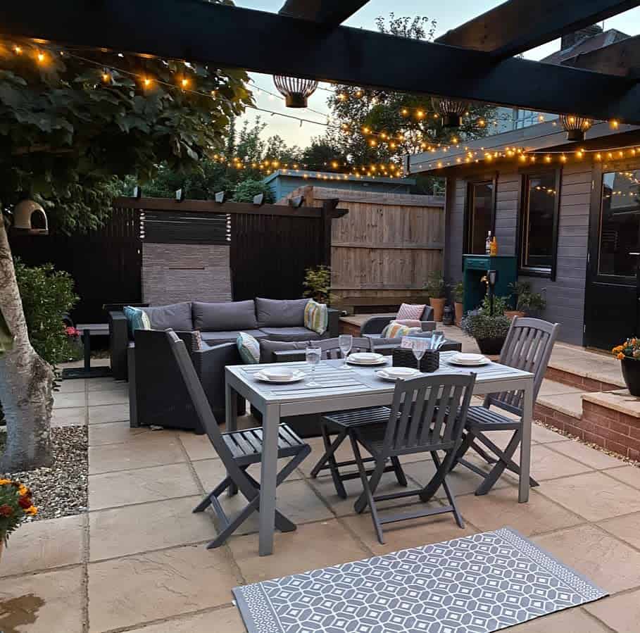 Large backyard patio with gray furniture 