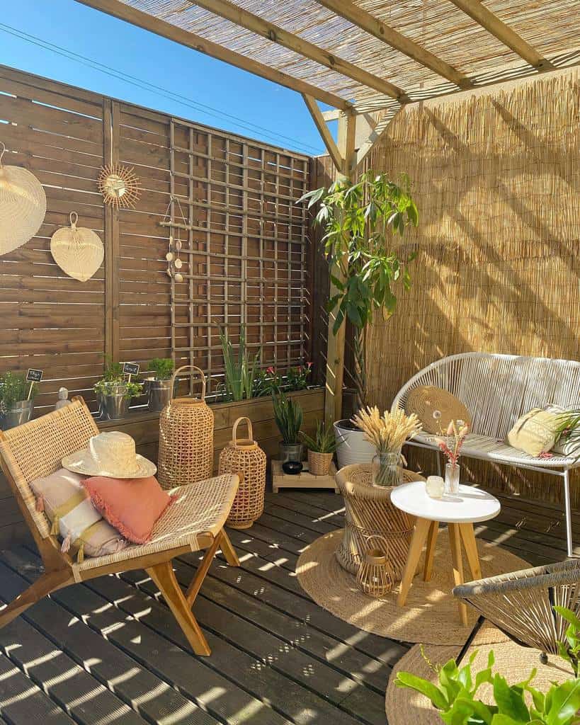 Wooden terrace with wicker furniture and bamboo privacy fence 