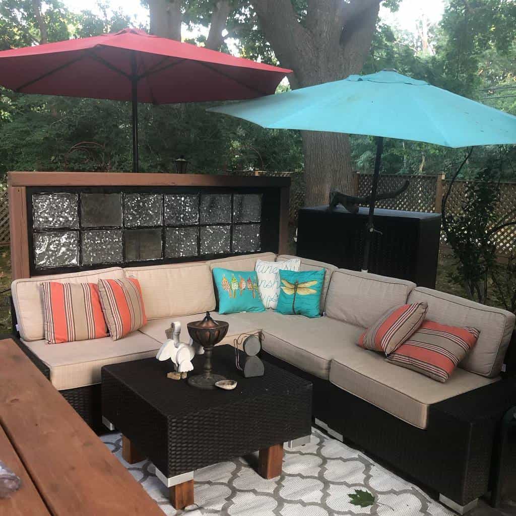 Corner terrace with L-shaped sofa and parasols 