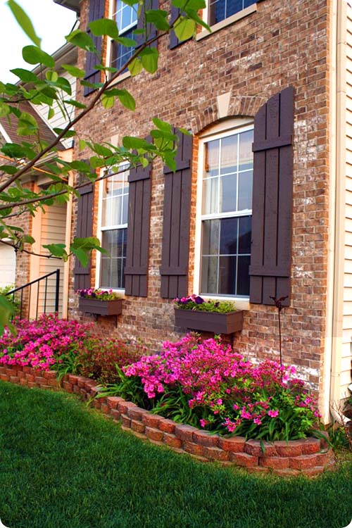 Raised brick flower bed around the house